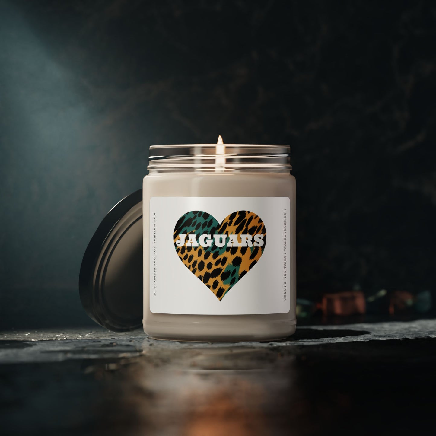 Candle with a jaguar print heart and 'Jaguars' text on a dark background