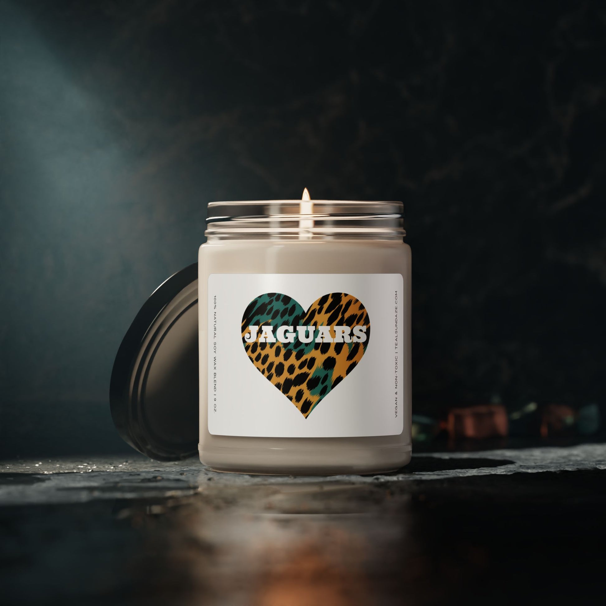 Candle with a jaguar print heart and 'Jaguars' text on a dark background