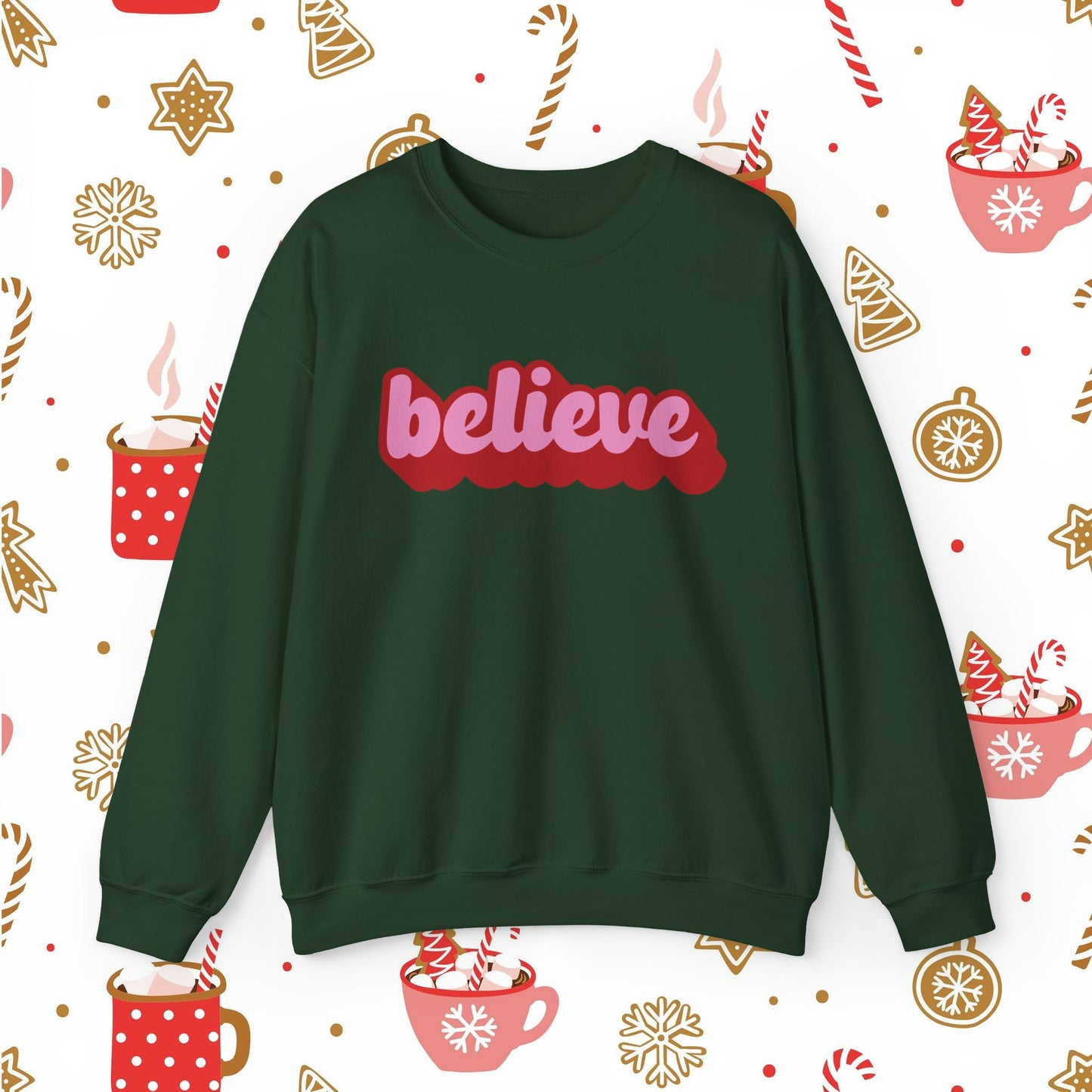 Green sweatshirt with 'believe' text on a festive background with Christmas elements.